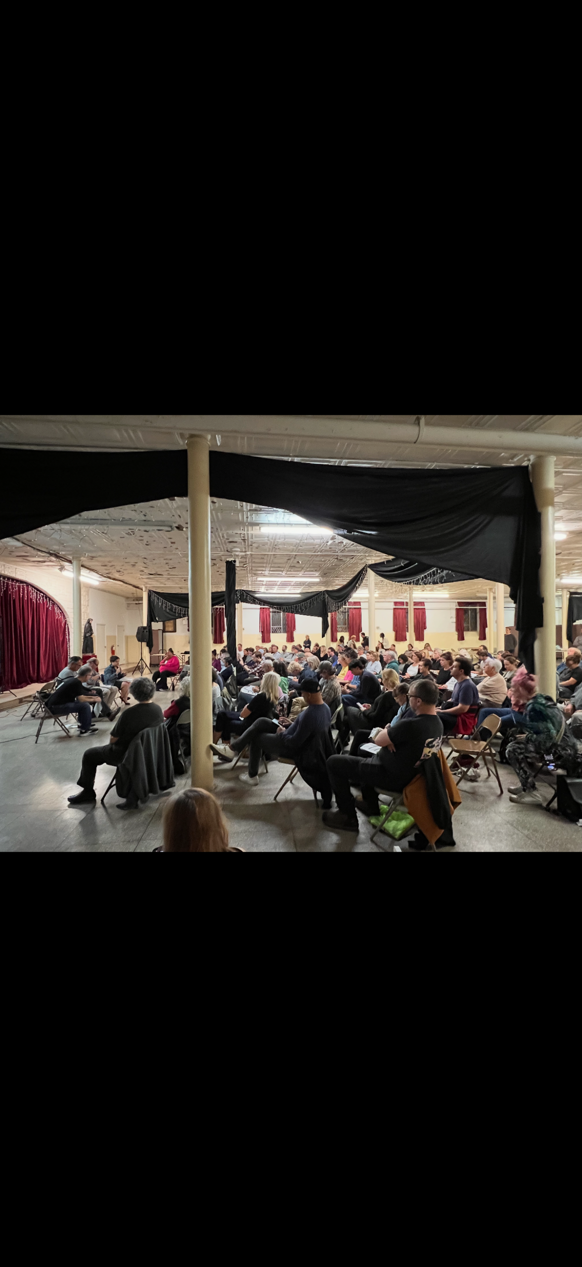 People seated listening to a panel